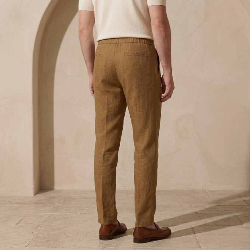 Men's cotton linen trousers by FJØRNA with relaxed fit and drawstring waist, showcasing lightweight, breathable fabric and comfortable style.
