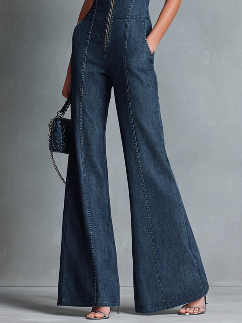 Dark denim flared jumpsuit for women with high neck, zipper front, sleeveless design, by FJØRNA.