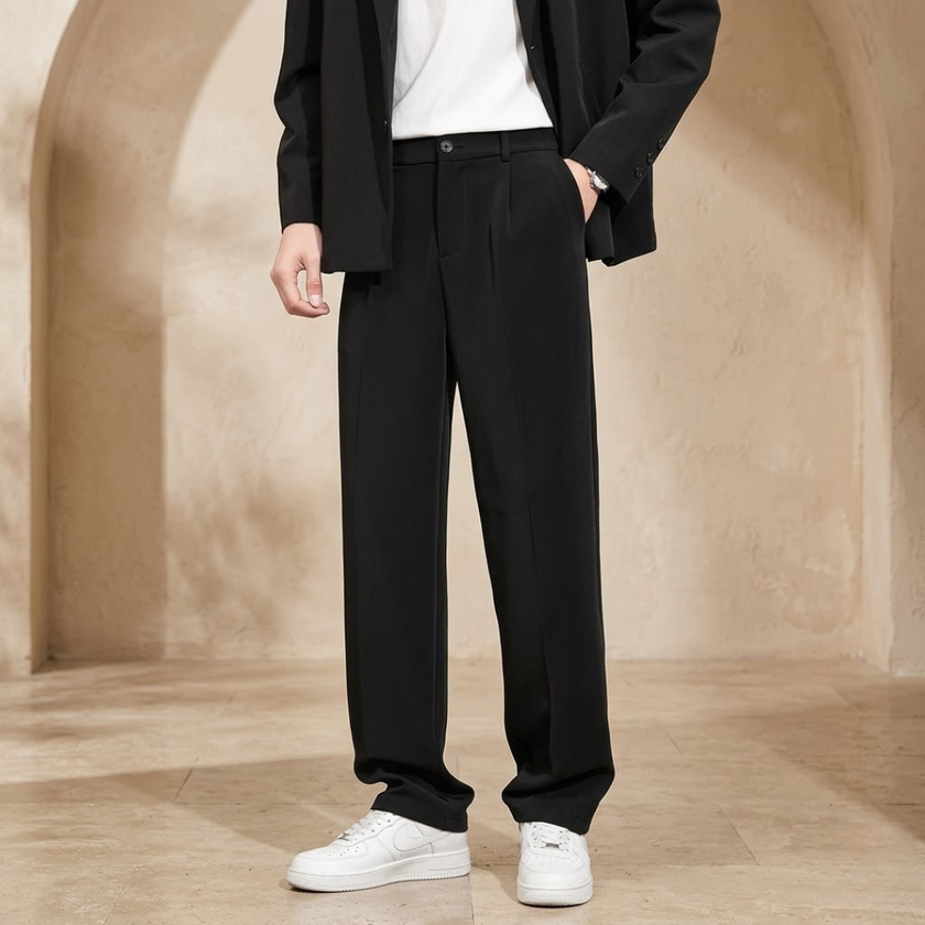 Men's pleated relaxed fit trousers by FJØRNA, showing the stylish waistband and tailored pleats on the relaxed-fit pants.