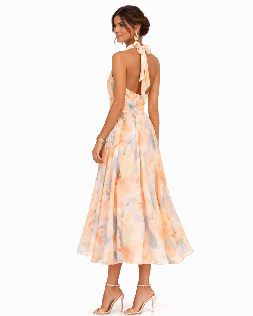 FJØRNA elegant maxi dress for women with a printed halter neck design, flowing fabric and stylish silhouette.
