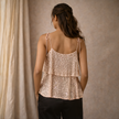 Shimmering men's sequin top from FJØRNA featuring a fitted design and sparkling sequin embellishments on a black fabric.