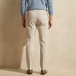 FJØRNA men's straight leg trousers, stylish and tailored pants for men, shown in a neutral color on a model.