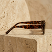 Retro rectangular FJØRNA unisex sunglasses with bold frames, stylish accessory for women and men.