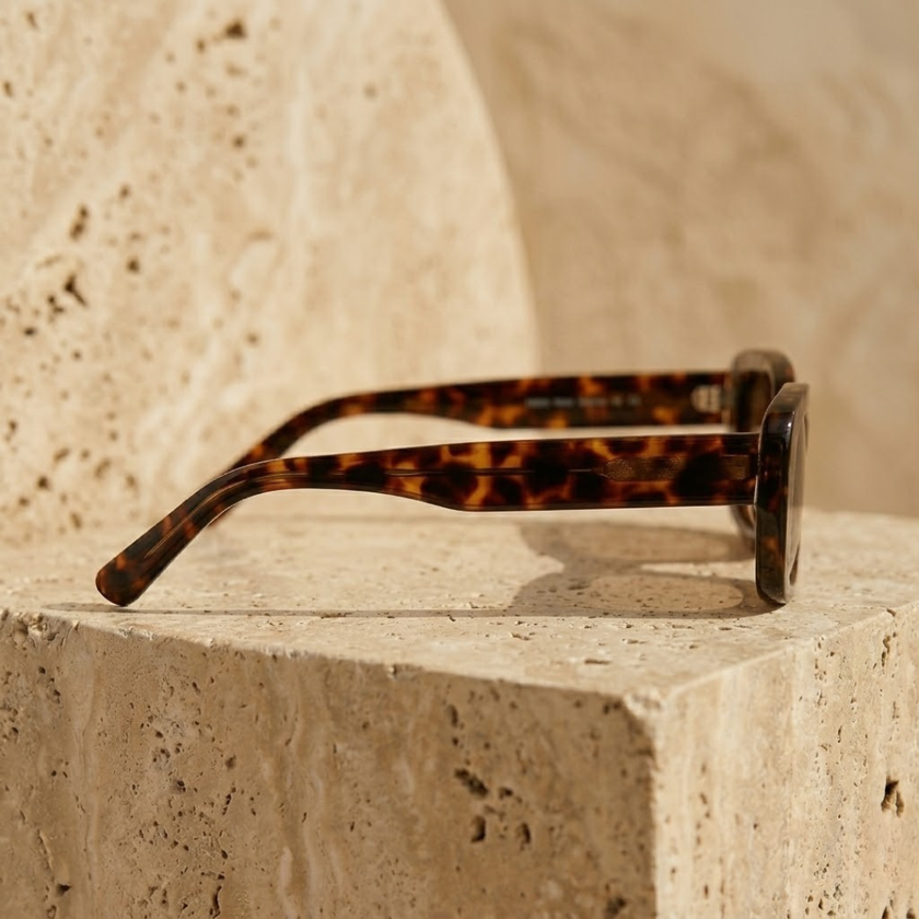 Retro rectangular FJØRNA unisex sunglasses with bold frames, stylish accessory for women and men.