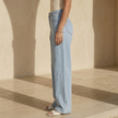 Women’s high waisted wide leg denim jeans by FJØRNA, showing the fit and style with a focus on the high waist and wide leg design.