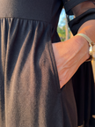 Elegant FJØRNA women's midi wrap dress in black, featuring a flattering silhouette and stylish evening wear design.