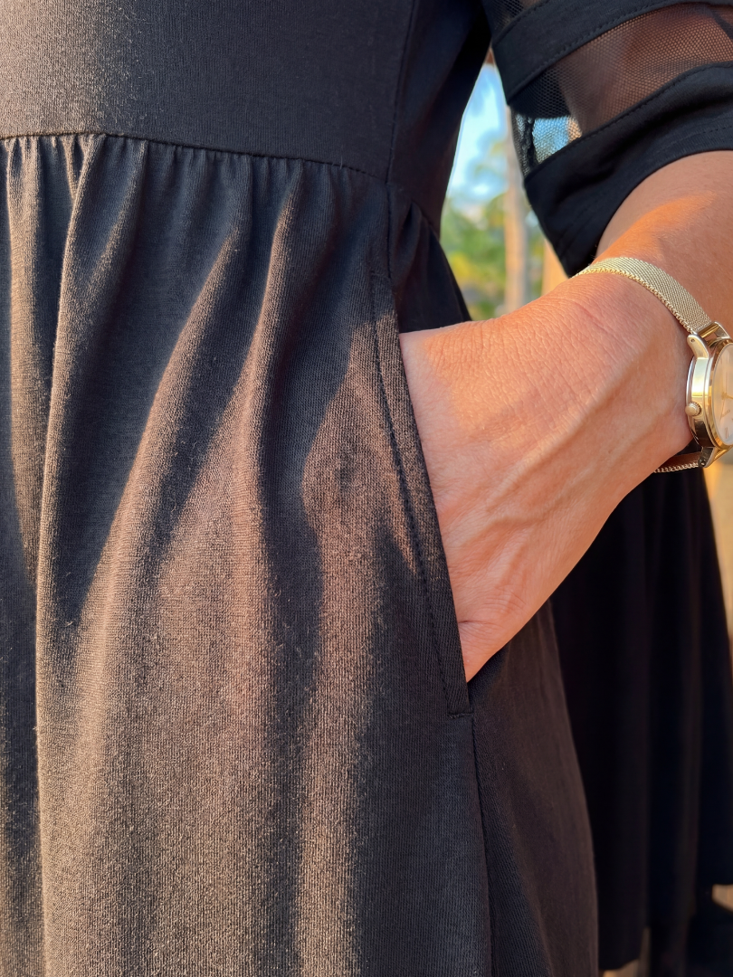 Elegant FJØRNA women's midi wrap dress in black, featuring a flattering silhouette and stylish evening wear design.