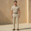 FJØRNA men's linen blend straight leg trousers with pleats, relaxed fit, and classic design, shown in a neutral color.