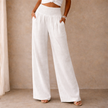 Women’s linen blend wide leg trousers by FJØRNA with elastic waist and relaxed fit, shown in a natural, relaxed pose.