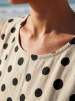 FJØRNA women's summer midi dress with polka dots, sleeveless design, lightweight fabric, and a flowy silhouette.