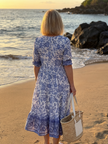 FJØRNA floral summer midi dress for women with a flowy, lightweight design and vibrant floral pattern.