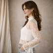 FJØRNA women's lace top with mock neck, stylish and elegant, featuring intricate lace details and a fitted design.
