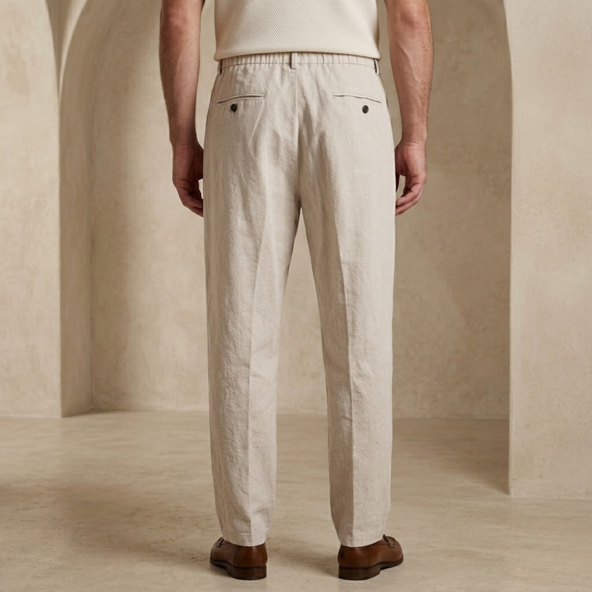 Men’s linen blend trousers by FJØRNA, lightweight casual summer pants in neutral fabric, displayed on a model.