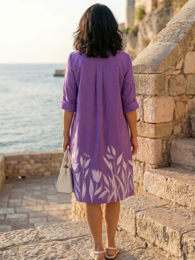 Elegant floral wrap evening dress for women by FJØRNA, featuring a stylish design and flowing fabric.