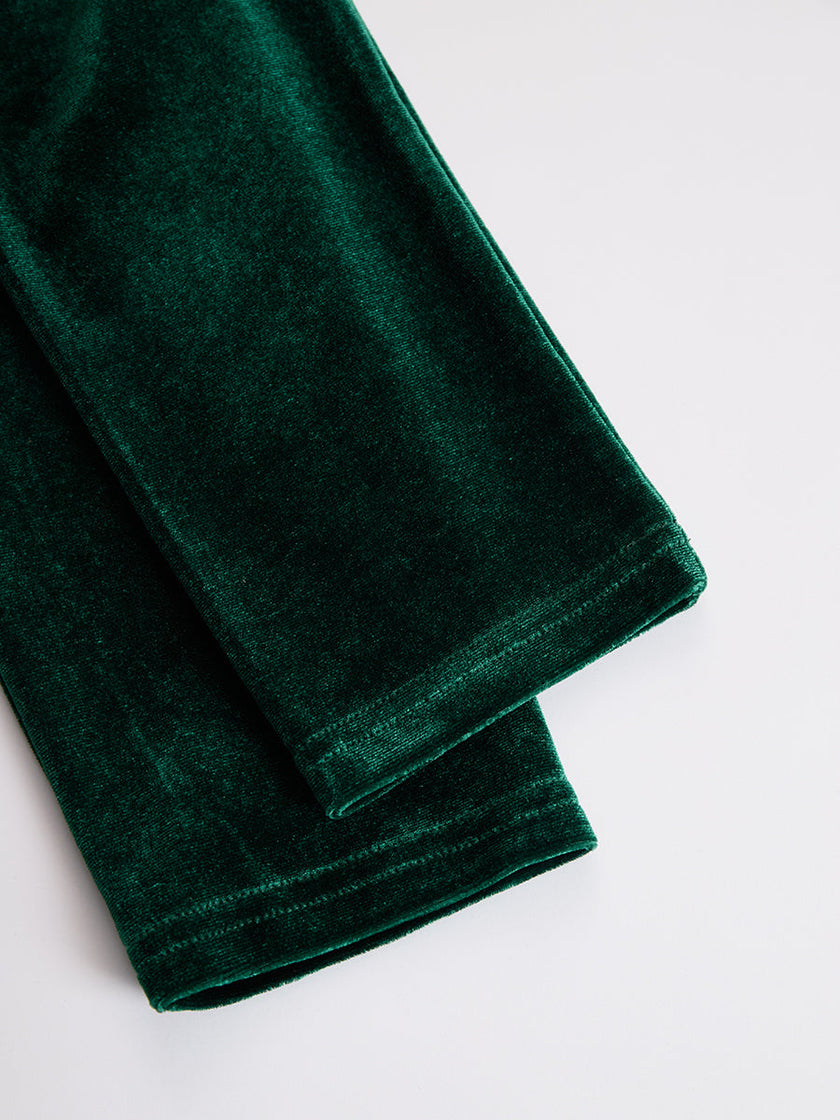 FJØRNA velvet midi dress for evening occasions, featuring a sleek silhouette and elegant fabric in a sophisticated design.