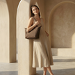 FJØRNA leather tote bag for women, large foldable design, stylish and spacious for everyday use, shown in natural leather finish.