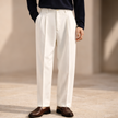 FJØRNA men's wide leg pleated trousers with relaxed fit, beige pants featuring a high waist and flowy silhouette.