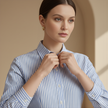 FJØRNA men's relaxed fit striped button-down shirt, casual top with vertical blue and white stripes, laid flat.