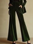 Emerald green velvet two-piece suit set by FJØRNA, featuring a loose blazer and matching wide-leg pants.