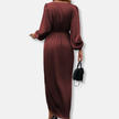 FJØRNA elegant midi dress for women with v-neck and long sleeves, showcased in a stylish, flowing design perfect for formal occasions.