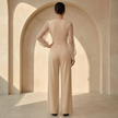 Women’s V neck mesh sleeve evening jumpsuit by FJØRNA, featuring a stylish V-neck design and sheer mesh sleeves.