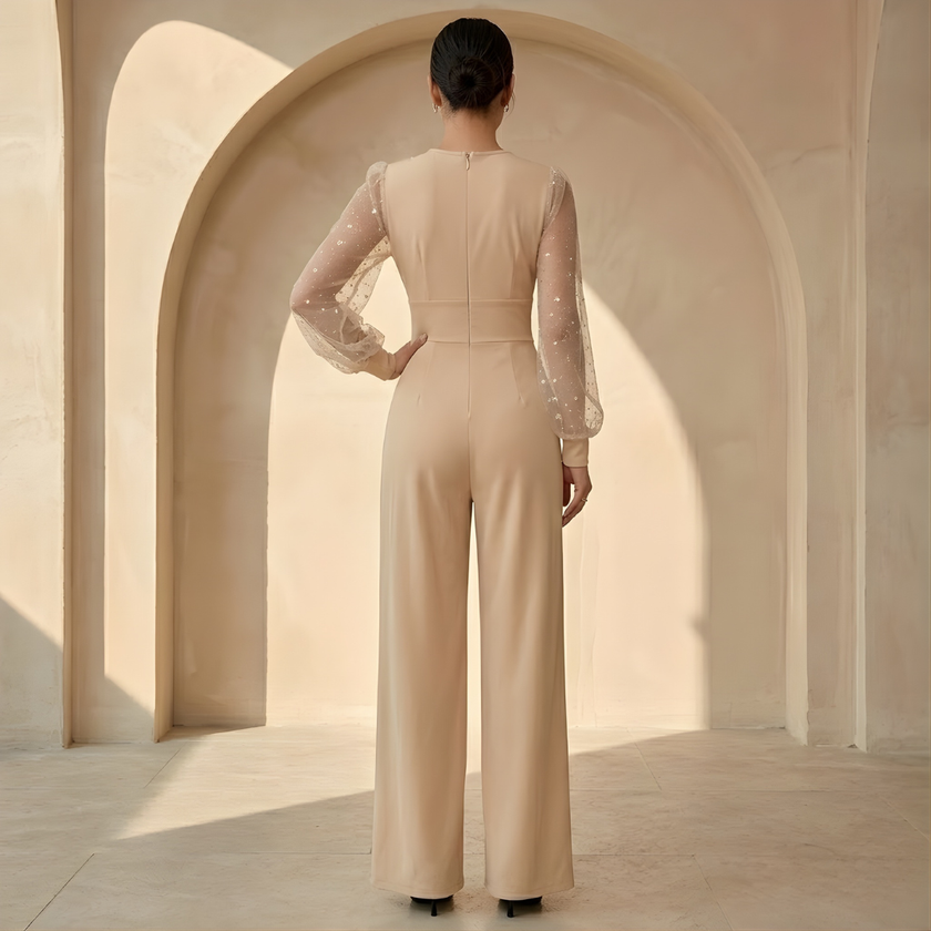 Women’s V neck mesh sleeve evening jumpsuit by FJØRNA, featuring a stylish V-neck design and sheer mesh sleeves.