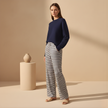 Women's FJØRNA striped drawstring trousers with a relaxed fit and casual waistband, featuring vertical stripe patterns.