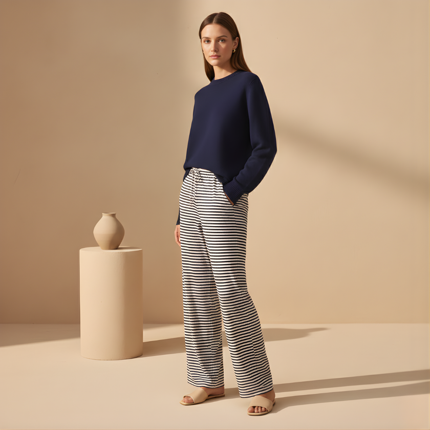 Women's FJØRNA striped drawstring trousers with a relaxed fit and casual waistband, featuring vertical stripe patterns.
