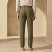 FJØRNA men's linen trousers with drawstring and pleated design, showcasing lightweight, breathable fabric and relaxed fit.