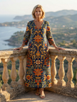 FJØRNA women's floral summer midi dress with long sleeves, wrap style, tailored fit, perfect for warm weather and elegant occasions.