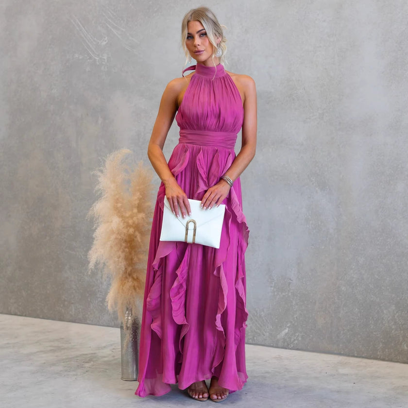 FJØRNA elegant women’s maxi dress with halter neck and ruffle details, flowing fabric and sleeveless design.