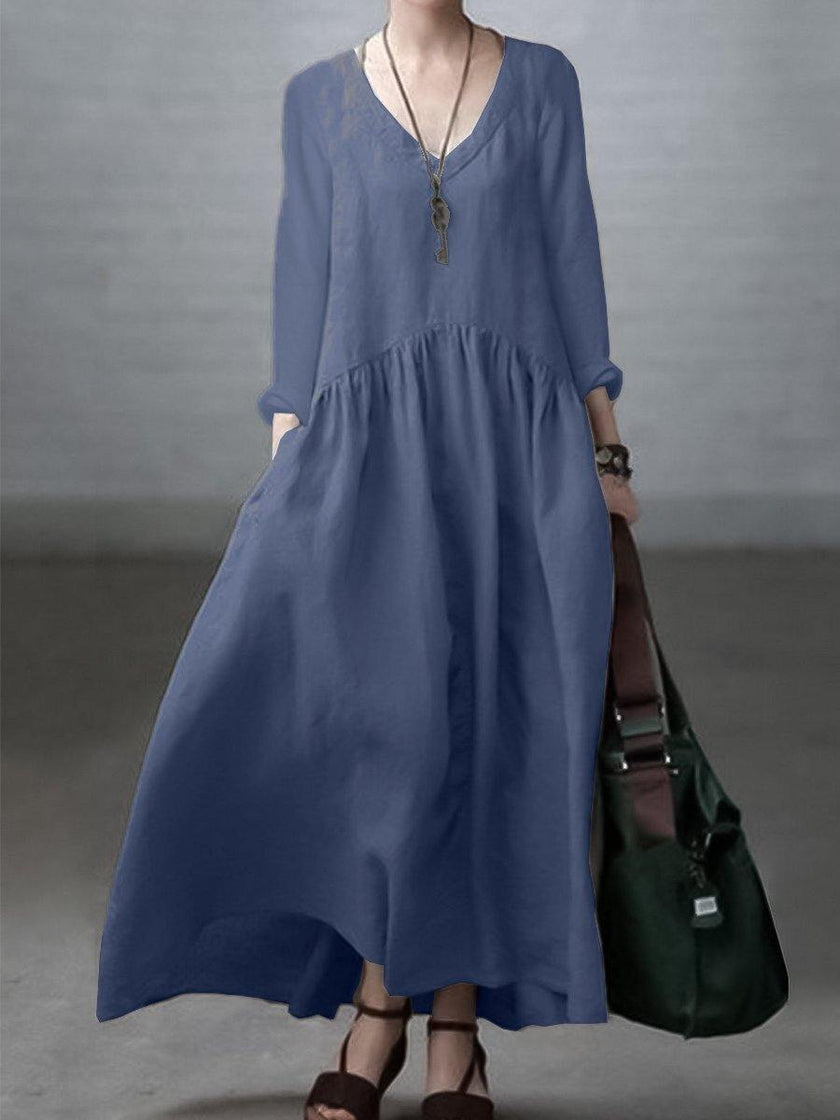 FJØRNA loose V-neck cotton and linen dress in a casual wedding style, featuring a relaxed fit and lightweight fabric.