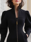 FJØRNA leather zippered midi dress with puffed long sleeves, stylish and fitted design perfect for elegant occasions.