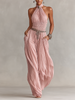 FJØRNA blush pleated women's jumpsuit with halter neck, ruched waist, and wide-leg pants, styled for a chic look