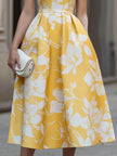 FJØRNA sleeveless floral print midi dress with a fitted bodice and flowing skirt, perfect for summer or casual occasions.