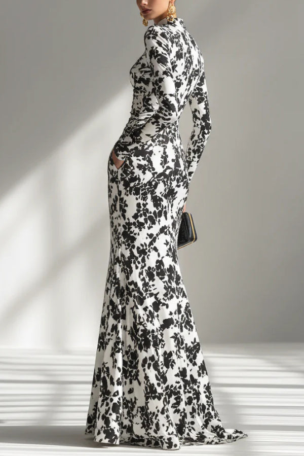 Black and white color-blocked printed long-sleeve maxi dress by FJØRNA featuring a slim fit, pleated skirt, and front pocket details.