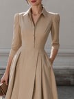 Beige FJØRNA pleated midi dress with shirt collar for women, featuring a flowy silhouette and stylish design.