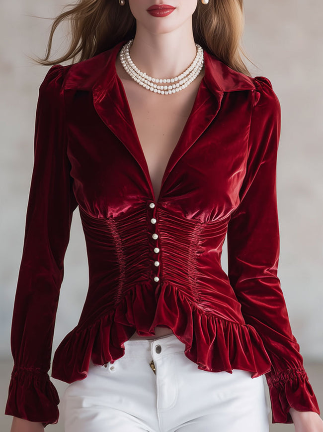 Red velvet pleated ruffled long sleeve blouse by FJØRNA featuring intricate ruffles and a fitted silhouette.