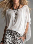 White chiffon button-up shirt for women by FJØRNA, lightweight and stylish, shown on a model with a casual fit.