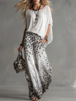 White chiffon button-up shirt for women by FJØRNA, featuring a classic collar and long sleeves, hanging on a hanger.