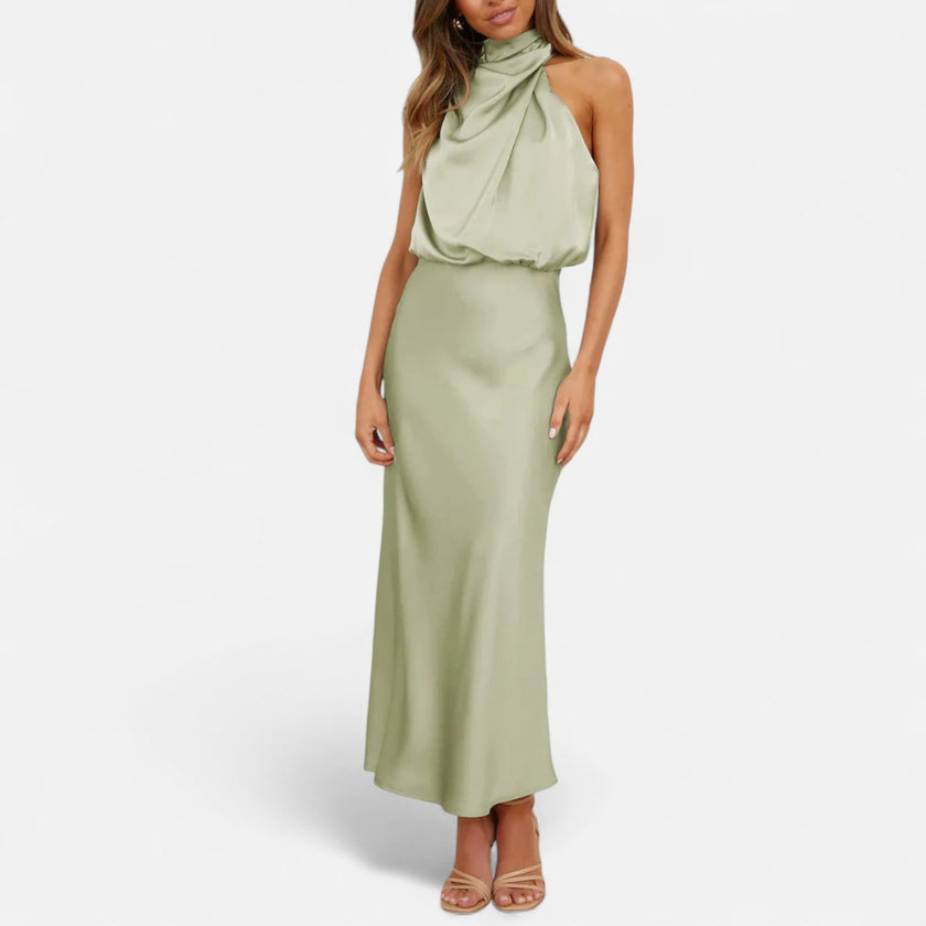 FJØRNA sleeveless halter maxi dress with draped design, flowing fabric, and elegant silhouette perfect for formal occasions.