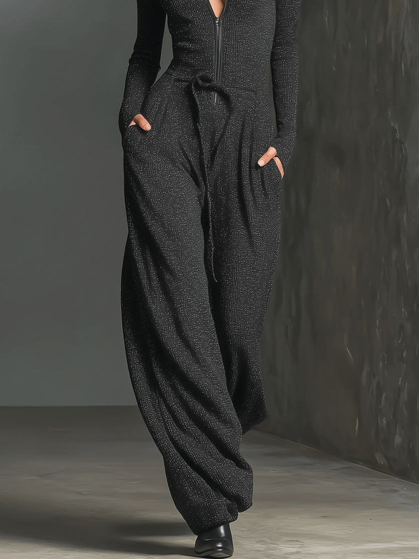 Sparkling knit jumpsuit for women with zip front, long sleeves, wide-leg pants, by FJØRNA, shown in a close-up view.