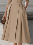 Beige FJØRNA pleated midi dress with shirt collar, sleeveless design, and button front, perfect for elegant daytime wear.