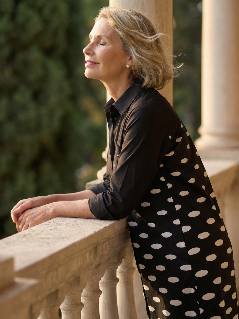 FJØRNA elegant women's polka dot dress with pockets, suitable for evening wear, featuring a flowing silhouette and classic design.