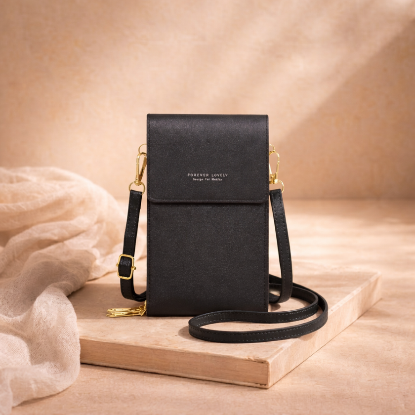 FJØRNA women's crossbody bag in black with adjustable strap and silver hardware, stylish accessory for everyday wear.