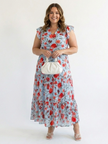 FJØRNA women's floral tiered summer midi dress hanging on a hanger, showcasing lightweight fabric and vibrant floral pattern.