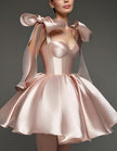 Light pink satin cocktail dress for women with sweetheart neckline, corset style, and bow detail by FJØRNA.