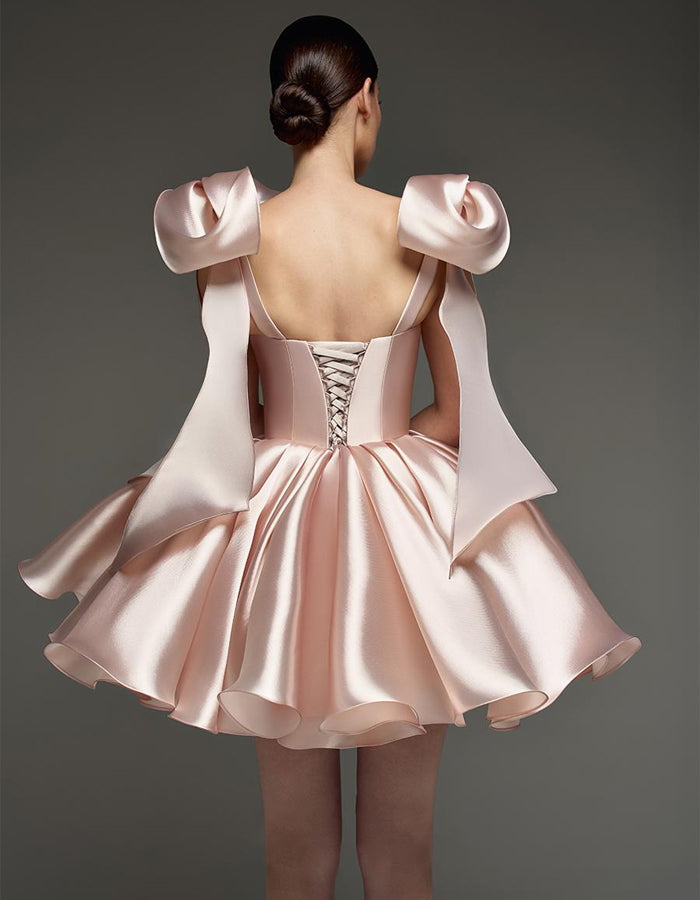 Light pink satin cocktail dress for women with sweetheart neckline, corset style, and bow detail by FJØRNA.