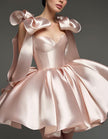 Light pink satin cocktail dress for women with sweetheart neckline, corset style, and bow detail by FJØRNA