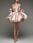 Light pink satin cocktail dress for women with sweetheart neckline, corset bodice, and bow detail by FJØRNA.